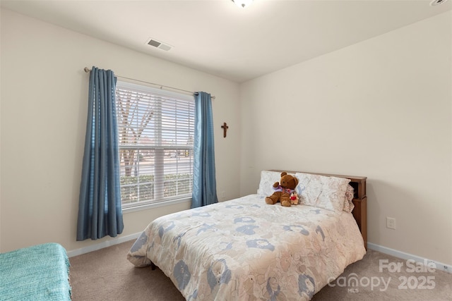 bedroom featuring carpet, visible vents, and baseboards