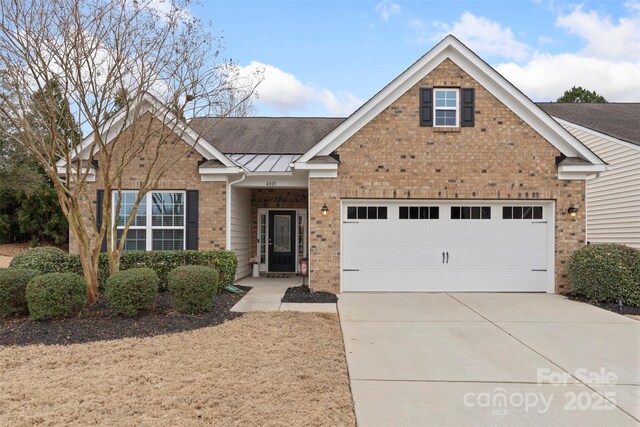 4001 Perth Rd, Fort Mill, SC 29707 - traditional home with driveway, a shingled roof, metal roof, brick siding, and a standing seam roof