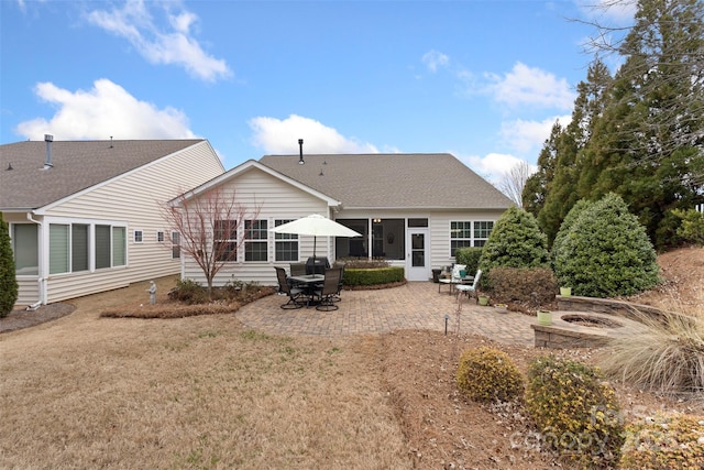 back of house featuring a fire pit and a patio area