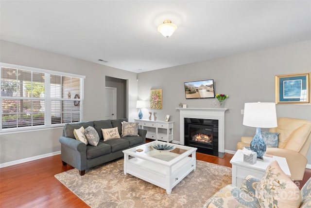 4001 Perth Rd, Fort Mill, SC 29707 - living area with a fireplace with flush hearth, light wood-style floors, visible vents, and baseboards