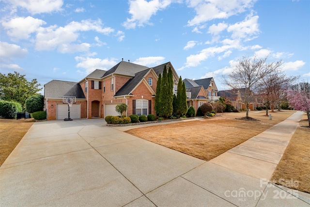 view of front of home with a garage, concrete driveway, and brick siding