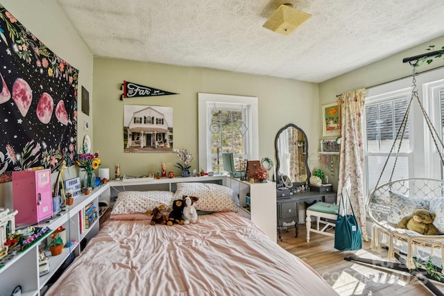 interior space featuring a textured ceiling and wood finished floors