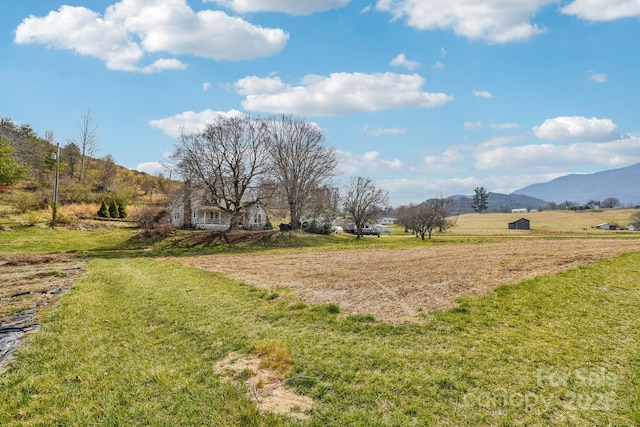 view of yard featuring a mountain view and a rural view