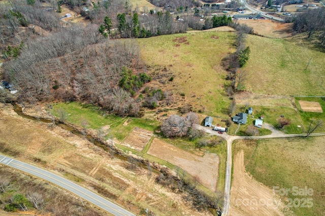 birds eye view of property with a rural view