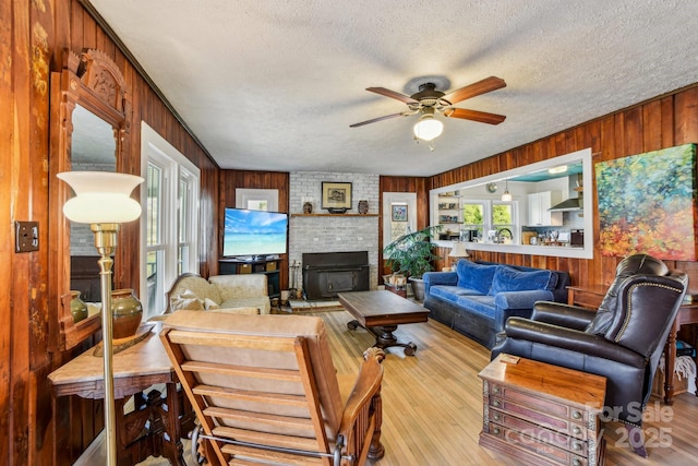 living room featuring wooden walls and ceiling fan