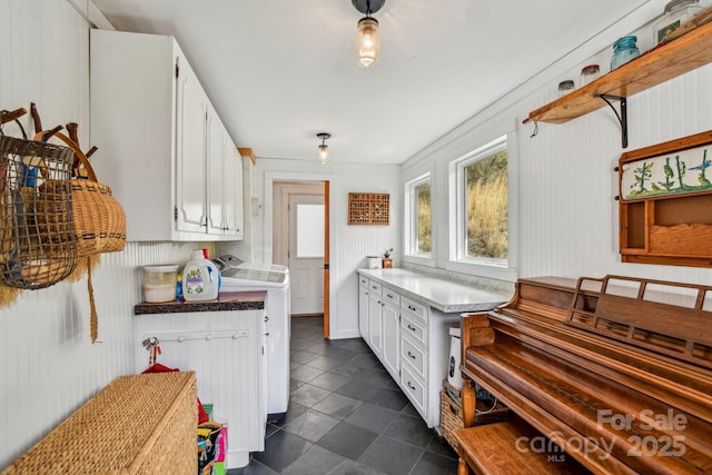 kitchen featuring radiator, white cabinetry, and light countertops