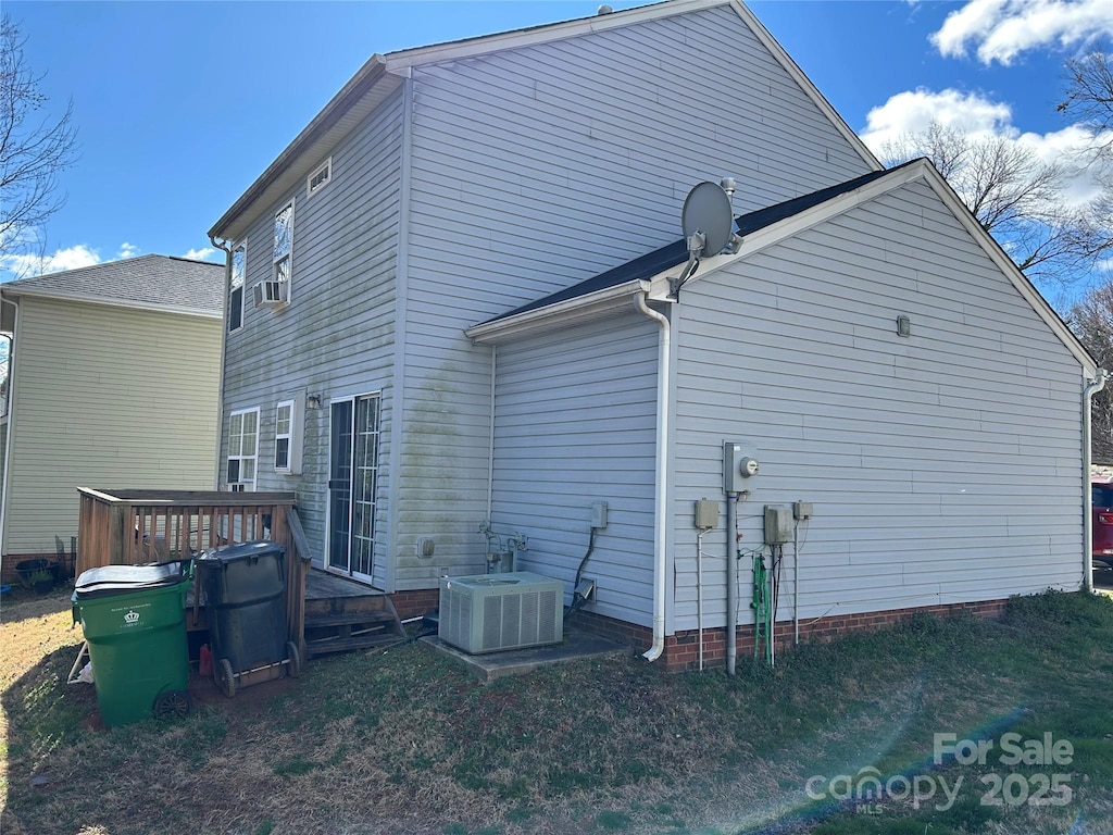 back of house with central AC