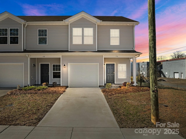 view of front of property featuring a garage and concrete driveway