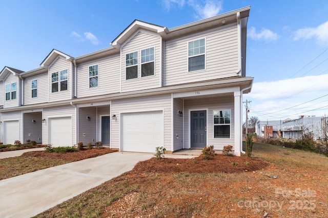 townhome / multi-family property featuring a garage and driveway