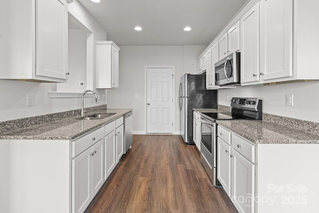 kitchen with stainless steel appliances, white cabinets, and a sink