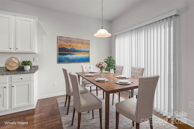 dining area featuring dark wood-style floors and baseboards