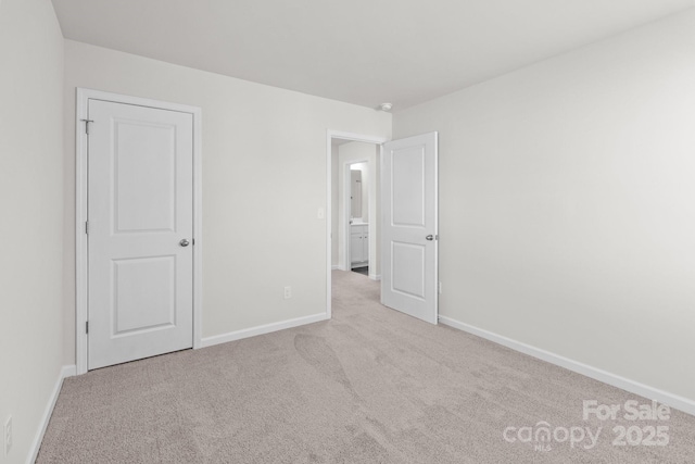 unfurnished bedroom featuring baseboards and carpet flooring