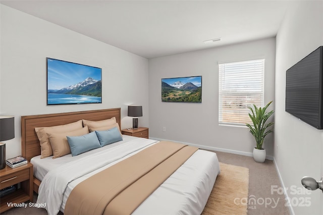 bedroom with light carpet, visible vents, and baseboards