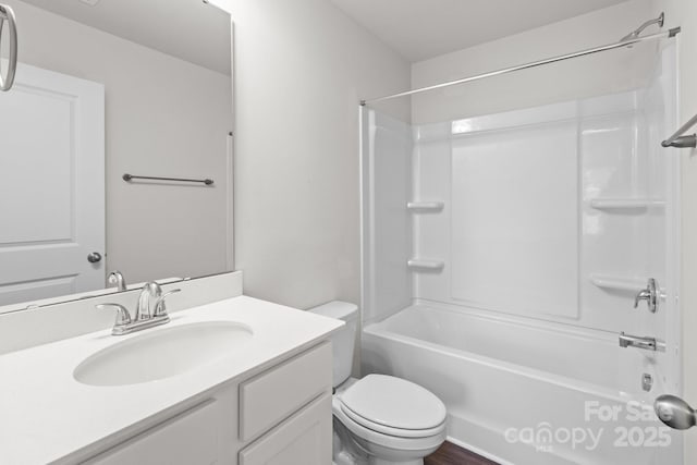 bathroom featuring toilet, shower / tub combination, and vanity