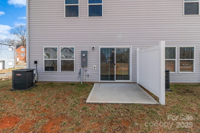 back of property featuring central air condition unit, a patio area, and a yard