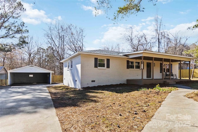 single story home featuring crawl space, an outbuilding, a porch, and brick siding