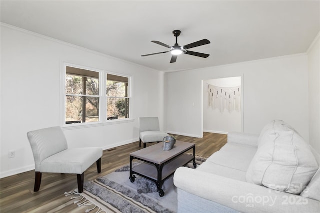 living room with ornamental molding, wood finished floors, visible vents, and baseboards