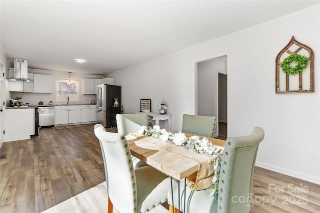 dining room with baseboards and wood finished floors