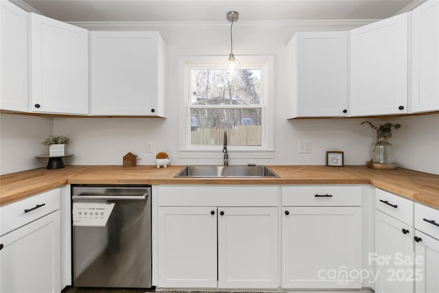 kitchen featuring a sink, butcher block counters, white cabinets, and dishwasher