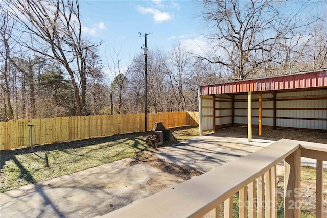 view of yard featuring an outbuilding, an outdoor structure, and fence