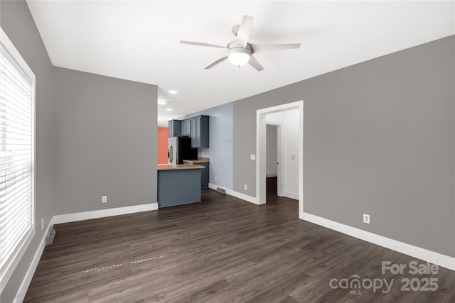 unfurnished living room with dark wood-style floors, visible vents, baseboards, recessed lighting, and ceiling fan