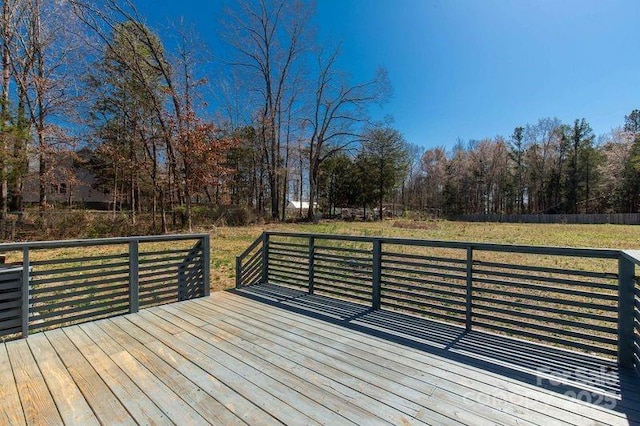 wooden deck featuring a yard