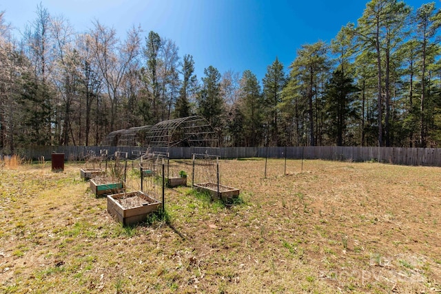 view of yard with a vegetable garden and fence