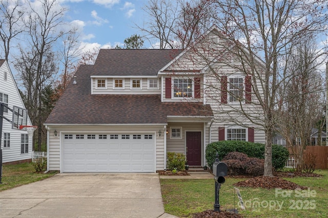 view of front of property featuring driveway, a shingled roof, a front yard, and fence