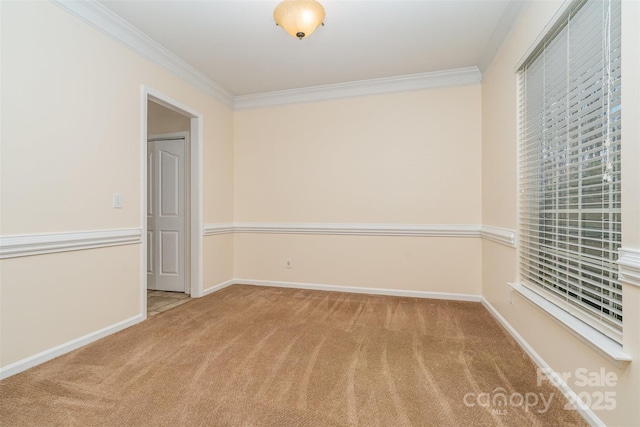 carpeted empty room with baseboards and ornamental molding