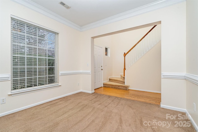 unfurnished room featuring visible vents, stairway, carpet floors, and ornamental molding