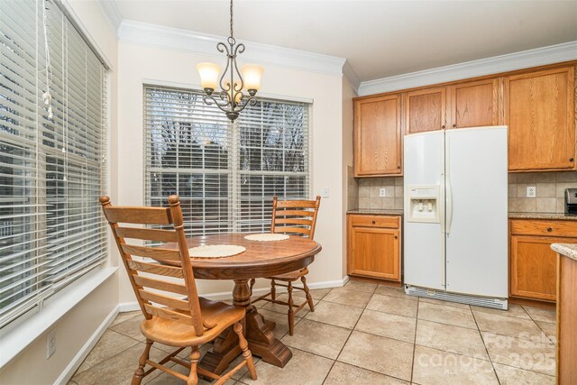 kitchen with decorative backsplash, white refrigerator with ice dispenser, and crown molding