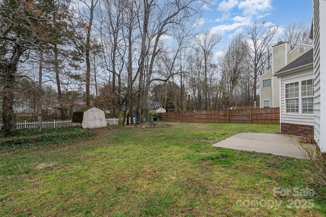 view of yard featuring a patio area, a fenced backyard, a storage unit, and an outdoor structure