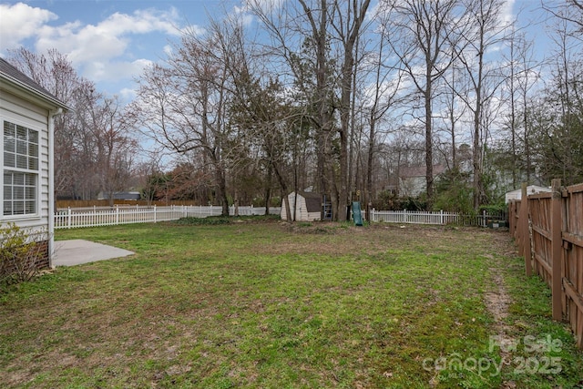 view of yard featuring an outdoor structure, a storage unit, a fenced backyard, and a patio area