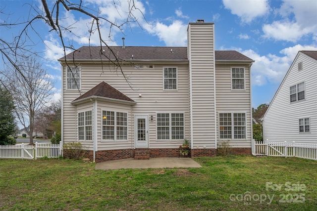 rear view of property featuring a patio area, a chimney, a yard, and a gate