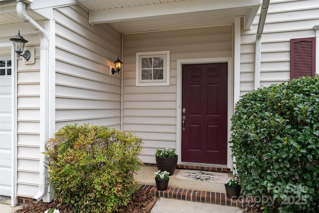 property entrance featuring an attached garage