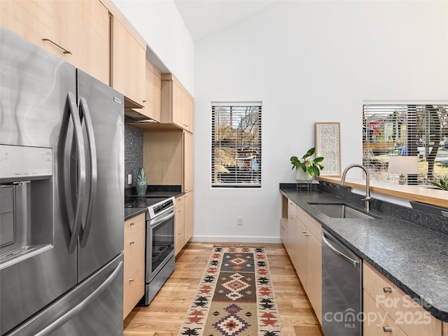 433 W Haywood St, Asheville, NC 28801 - kitchen featuring light brown cabinetry, stainless steel appliances, a sink, baseboards, and high vaulted ceiling