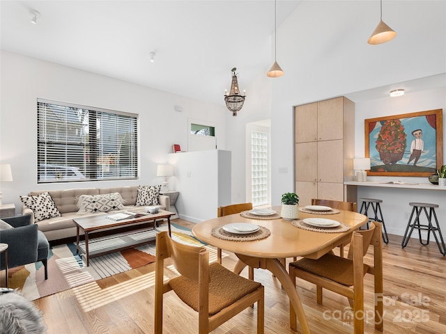 433 W Haywood St, Asheville, NC 28801 - dining space with baseboards, a chandelier, and light wood-style floors