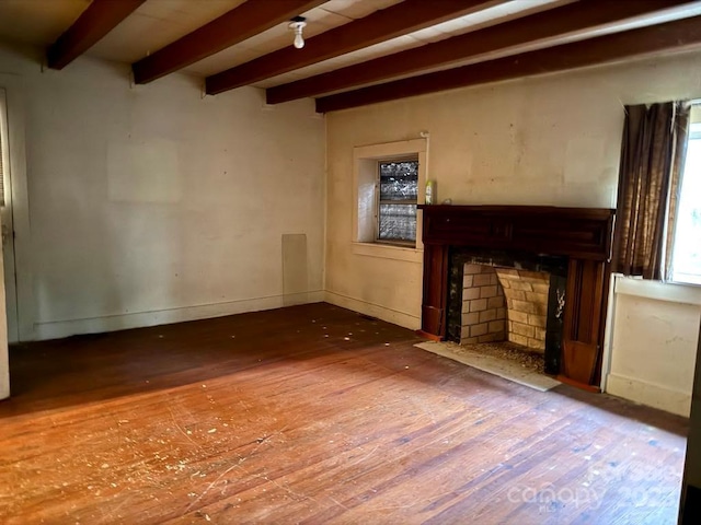 2412 Daves Dr, Shelby, NC 28152 - unfurnished living room with wood-type flooring, beamed ceiling, and a fireplace with flush hearth