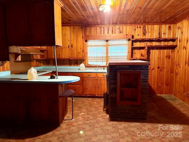 2412 Daves Dr, Shelby, NC 28152 - kitchen with wood ceiling, brown cabinets, wooden walls, and open shelves