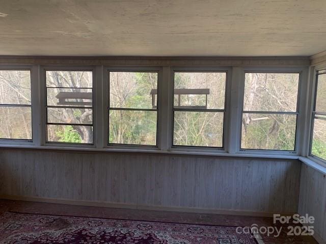 unfurnished sunroom with plenty of natural light