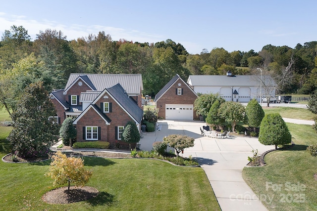 view of front of home with a garage, brick siding, and a front lawn