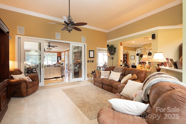 living room with light carpet, a ceiling fan, visible vents, and crown molding