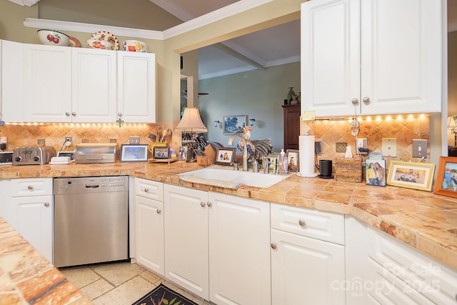 kitchen with a sink, ornamental molding, backsplash, and dishwasher