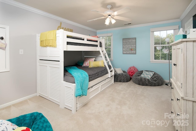 carpeted bedroom featuring a ceiling fan, visible vents, crown molding, and baseboards