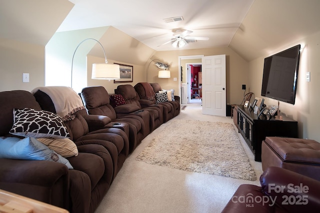 living area with light carpet, visible vents, vaulted ceiling, and a ceiling fan