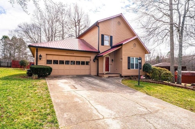 view of front of home featuring concrete driveway, an attached garage, a front yard, fence, and metal roof