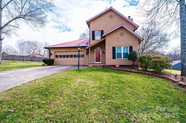 view of front facade with a front yard, metal roof, fence, a garage, and driveway