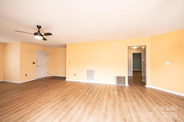 unfurnished room with light wood-style flooring, visible vents, ceiling fan, and baseboards