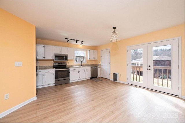 kitchen featuring a sink, visible vents, white cabinets, french doors, and appliances with stainless steel finishes