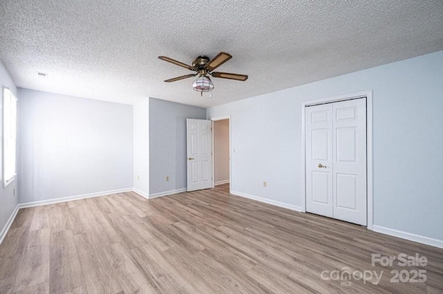 unfurnished bedroom with baseboards and wood finished floors